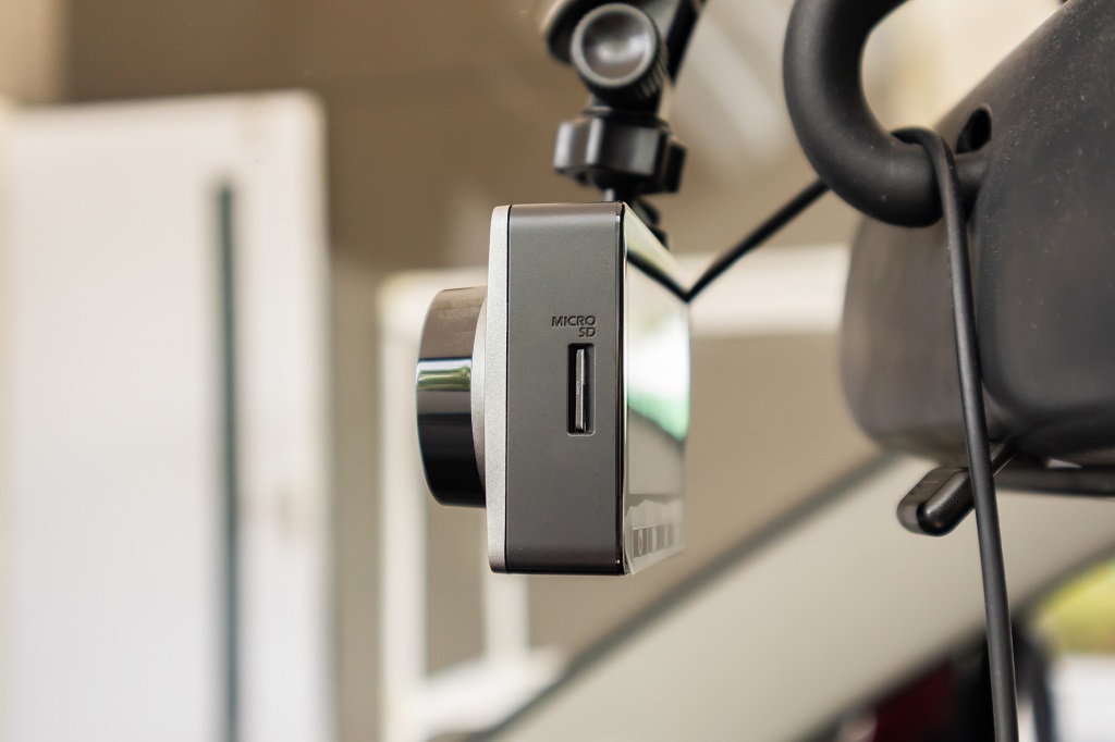 Close-up of dash cam with microSD card slot highlighting storage component